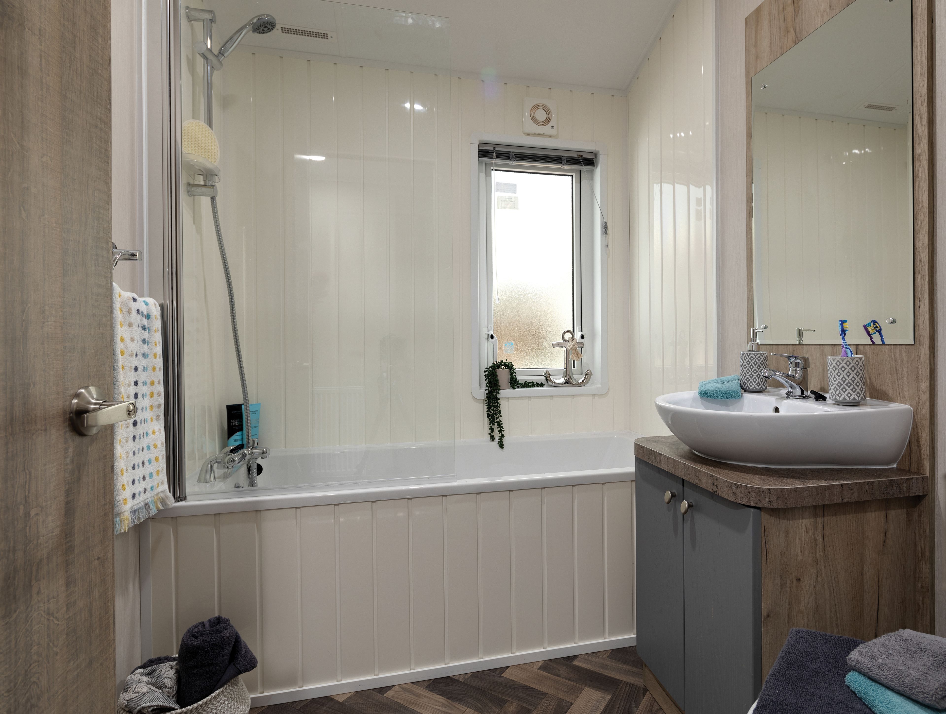 A modern bathroom with a bathtub, a sink, and a shower.