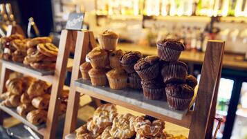 A bakery display with various baked goods like muffins and pastries.