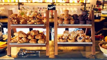 A bakery display with various pastries and a sign labeled "Pastry."