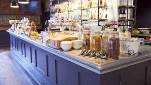 A breakfast buffet with various food items and beverages, including jars of cereal and a container labeled "Old Mout Cider." - Frederick Street Townhouse (Birmingham)