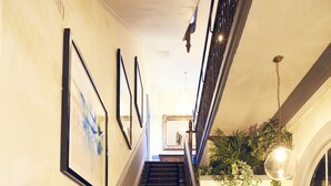 A staircase with patterned carpet, a wooden handrail, and framed pictures on the wall. - Frederick Street Townhouse (Birmingham)