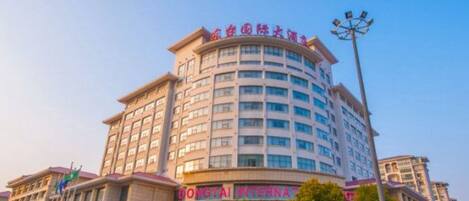 A multi-story hotel with a prominent signage indicating it is a Dongtai International hotel.