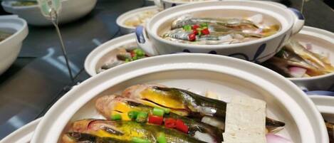A variety of dishes, including fish and vegetables, displayed in bowls.