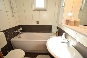 Apartment, 2 Bedrooms | Bathroom | Bathtub, free toiletries, towels, soap
