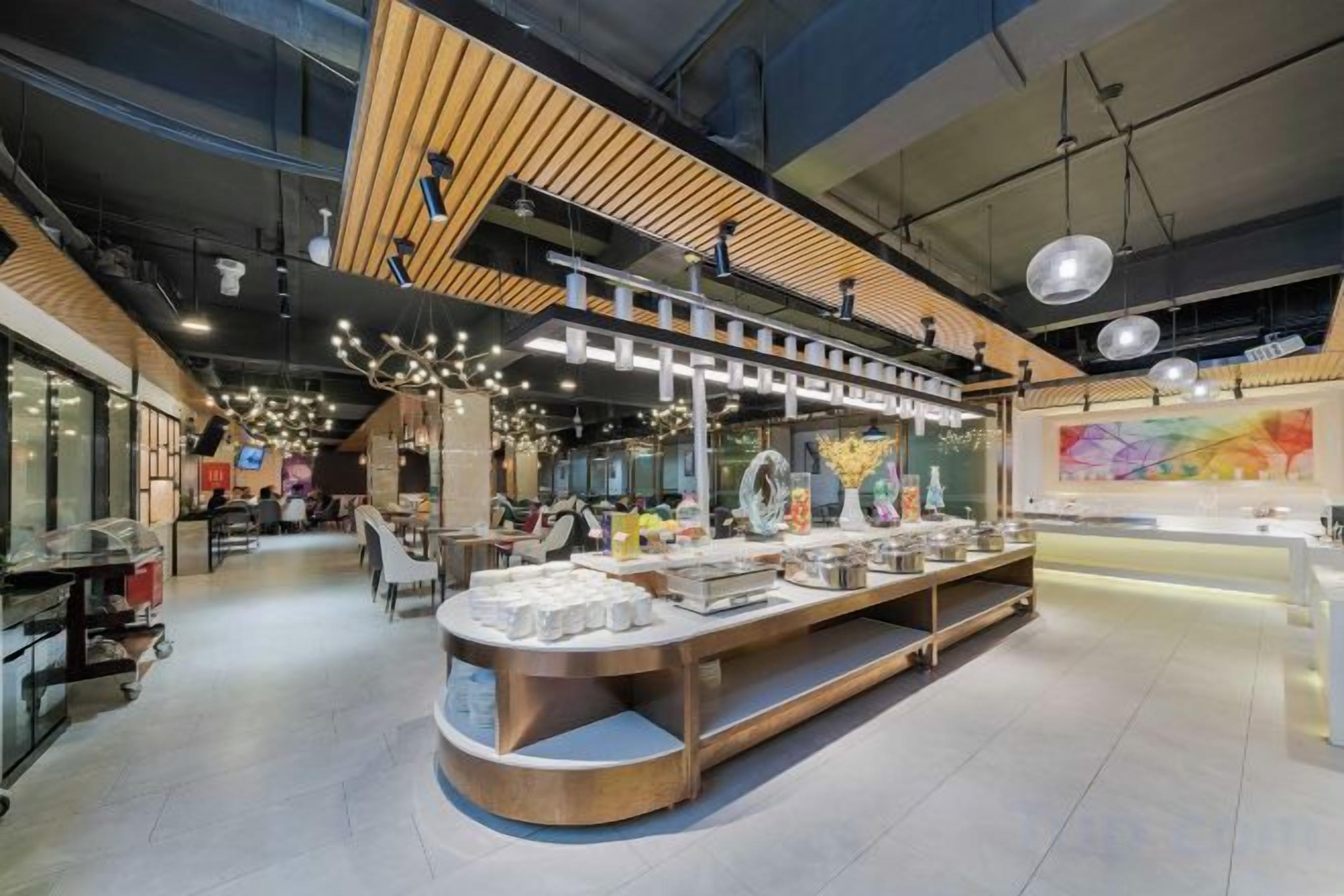 A modern interior with a central display counter, high ceilings, and a mezzanine level.