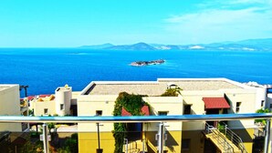A coastal view with buildings and a clear blue sea.