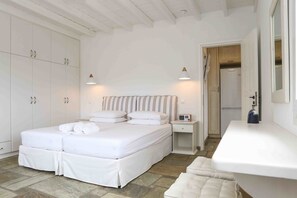 A bedroom with a bed, bedside table, and a nightstand. - VLIA MAR Myconian Residences (Mykonos)