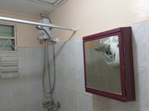 A bathroom with a shower, a mirror, and a towel rack. - Obaid's Condo in Winland Towers (Cebu City)