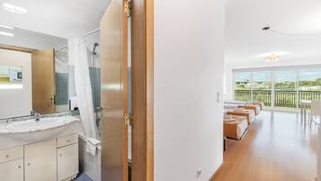 A modern bathroom with a sink, mirror, and shower.