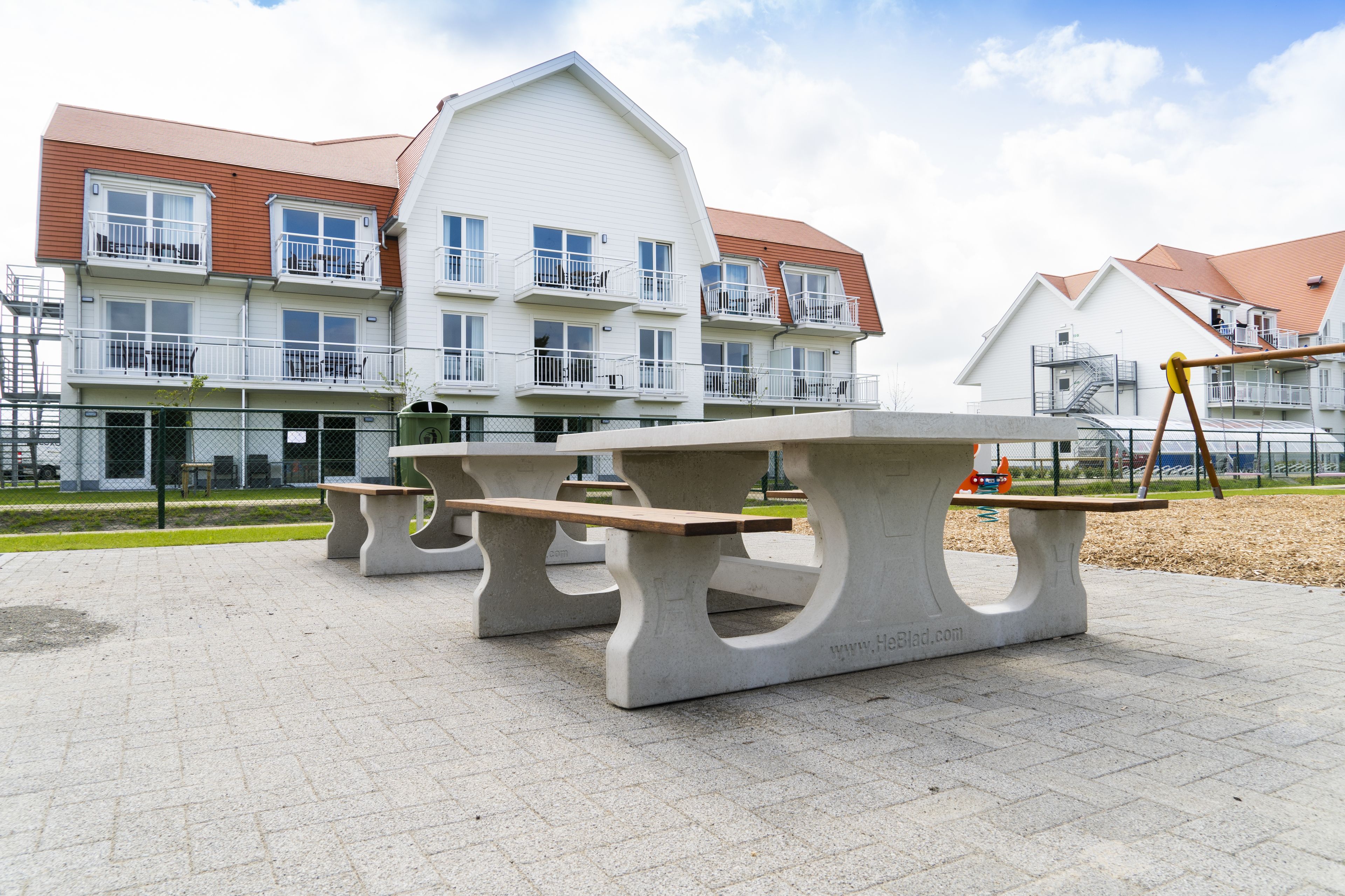 A park with picnic tables and a playground.