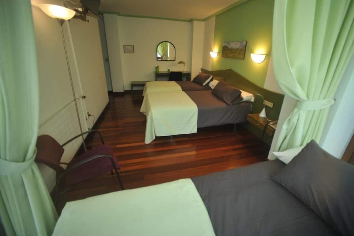 Triple Room | Desk, blackout drapes, WiFi (free), bed sheets