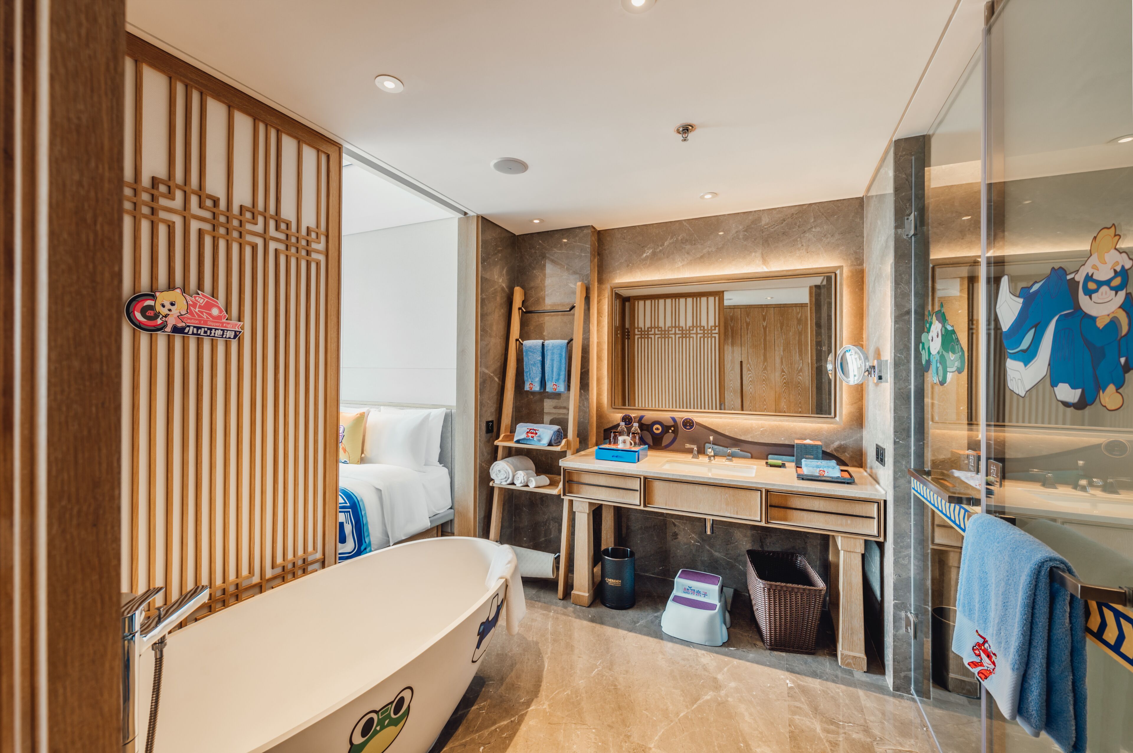 A modern bathroom with a bathtub, vanity, and a large mirror.