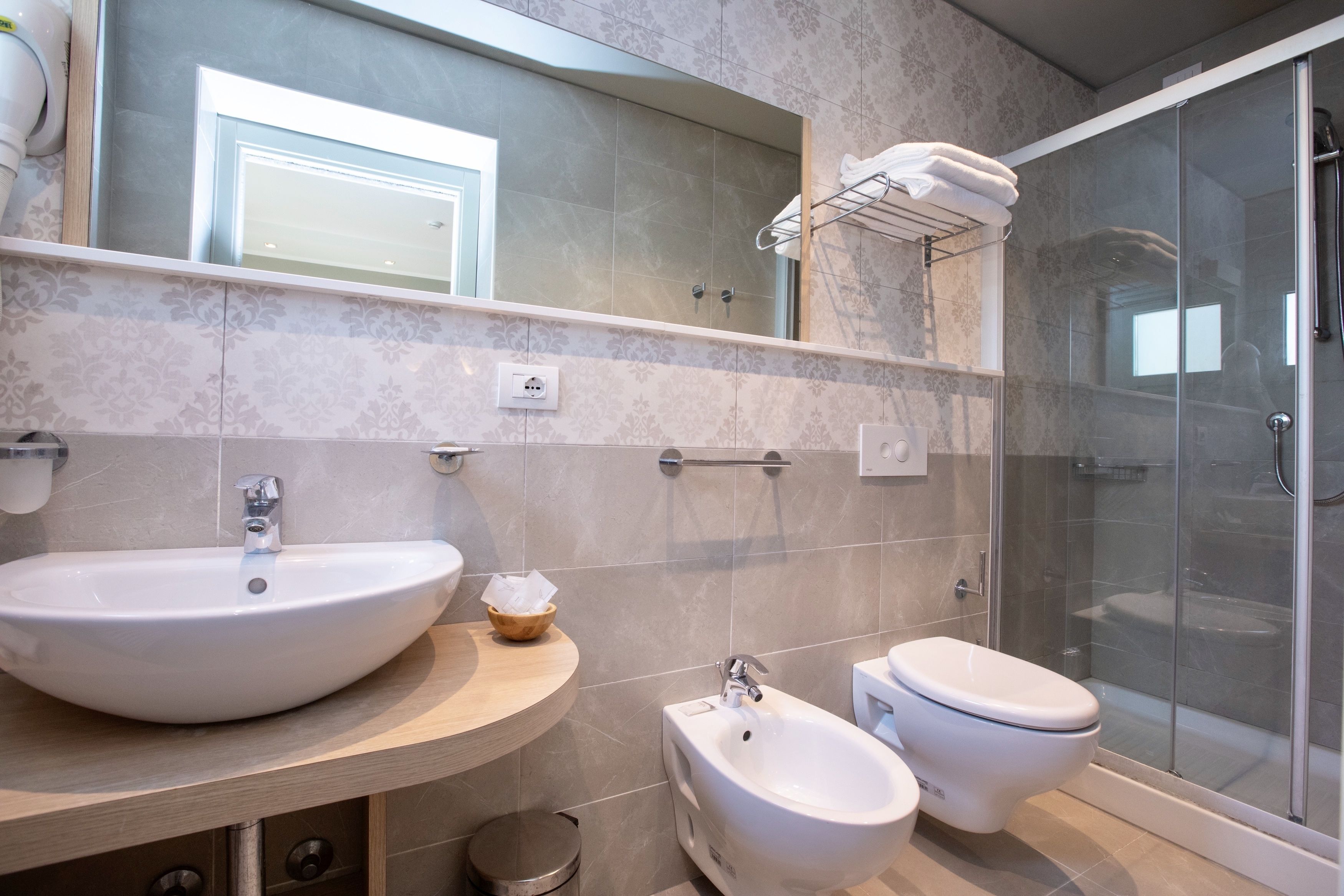 shower, hair dryer, bidet, towels