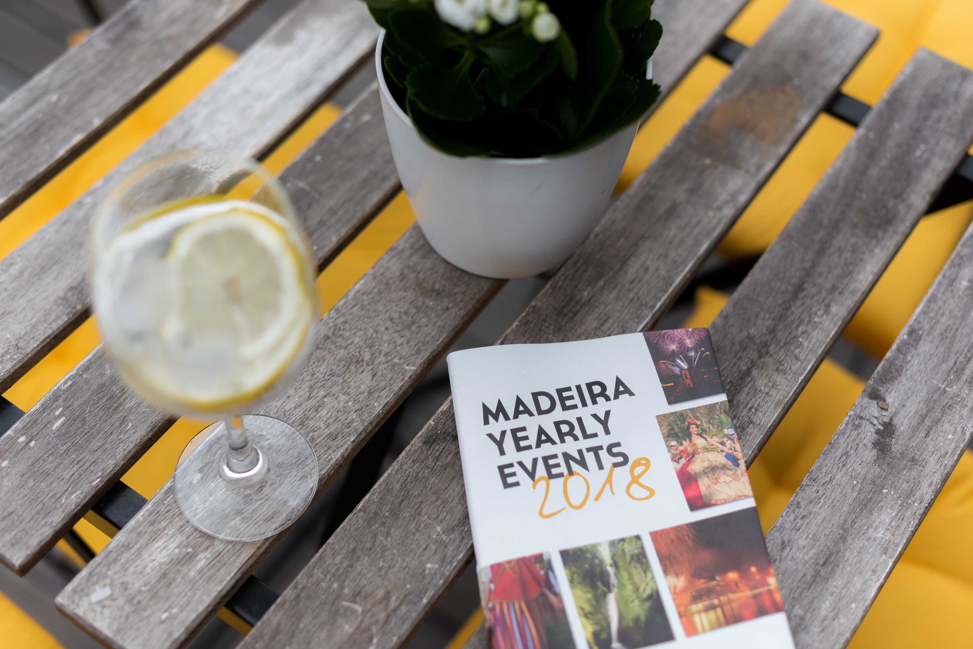 A brochure titled "MADEIRA YEARLY EVENTS 2018" on a wooden table.