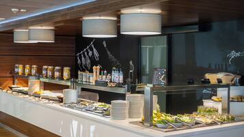 A buffet with various food items, condiment dispensers, and a chalkboard menu.