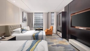 A hotel room with two beds, a TV, a small table, and a chair. - Zhenbao Holiday Hotel (Nanjing Olympic Sports Center) (Nanjing)