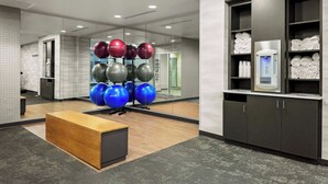 A modern fitness center with exercise balls, a reception desk, and a water dispenser. - Fairfield Inn & Suites by Marriott Memphis Collierville (Collierville)