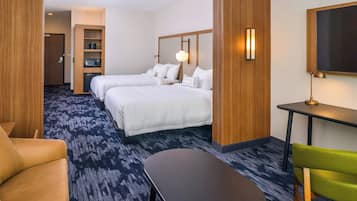 A hotel room with two beds, a desk, a chair, a TV, and a microwave.