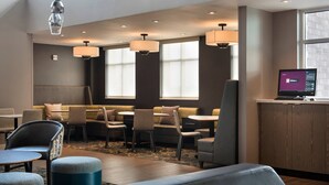 A modern hotel lobby with seating areas, a reception desk, and large windows. - Residence Inn by Marriott Lancaster (Lancaster)