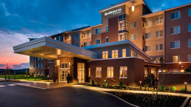 A multi-story hotel with a prominent entrance, a covered outdoor area, and a landscaped garden. - Residence Inn by Marriott Lancaster (Lancaster)