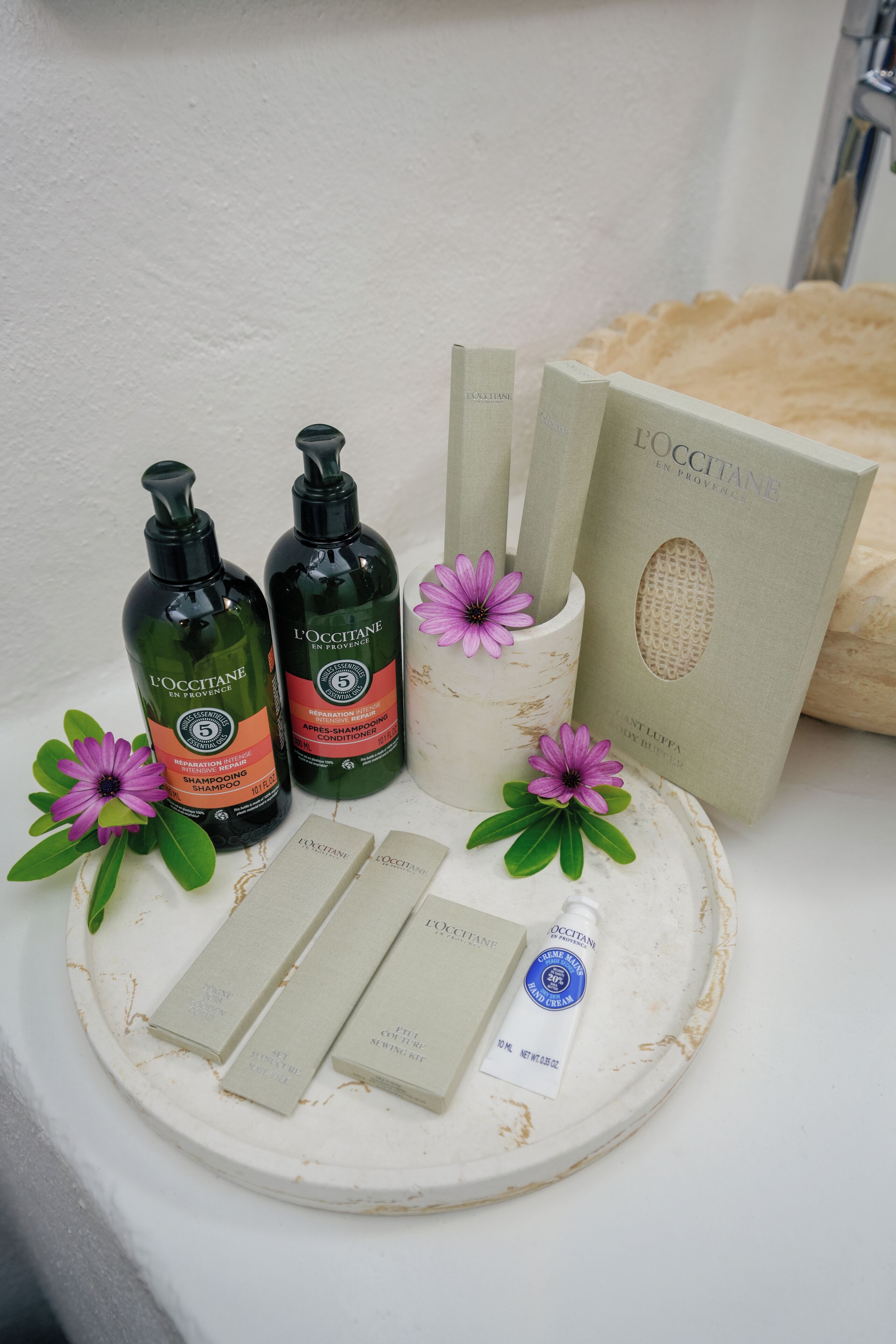 designer toiletries, hair dryer, slippers, towels