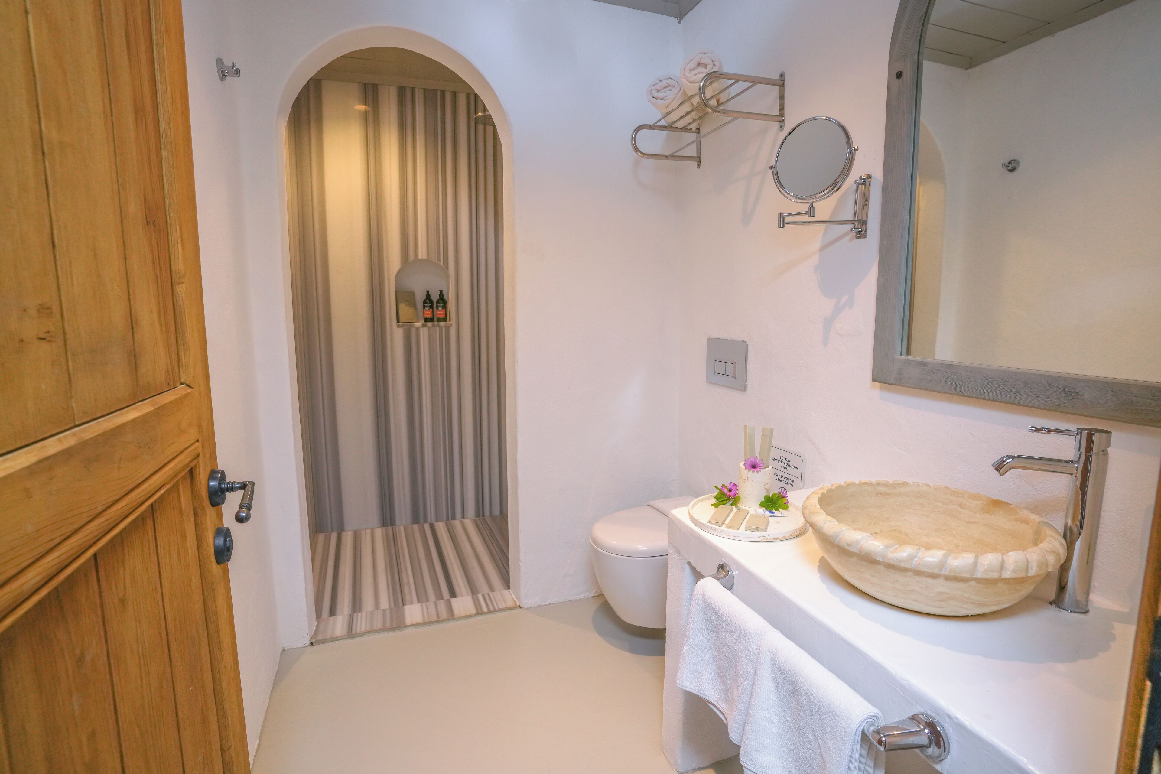 designer toiletries, hair dryer, slippers, towels