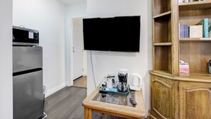 A kitchenette with a microwave, refrigerator, and a coffee maker on a glass table. - Beautiful House Fantastic View Azusa California (Azusa)