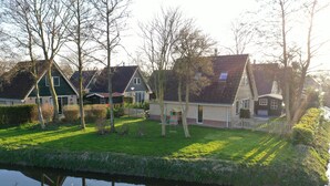 A row of houses with a canal in the foreground. - A beautiful house with incredible views on a corner lot (Sint Maarten)