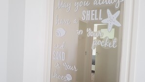 A doorway with a decorative sign that reads "May you always have a shell in your pocket."