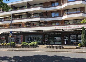 A multi-story building with a storefront labeled 'Appartementresidenz am Kurpark' and a visible 'KOSMETIK-STUDIO' sign.