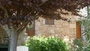 A stone building with a window and a door. - Quiet cottage with beautiful view (Chirols)