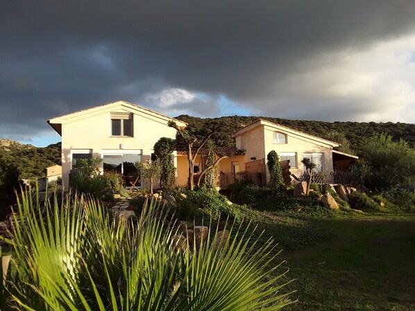 A two-story house with a garden in front.