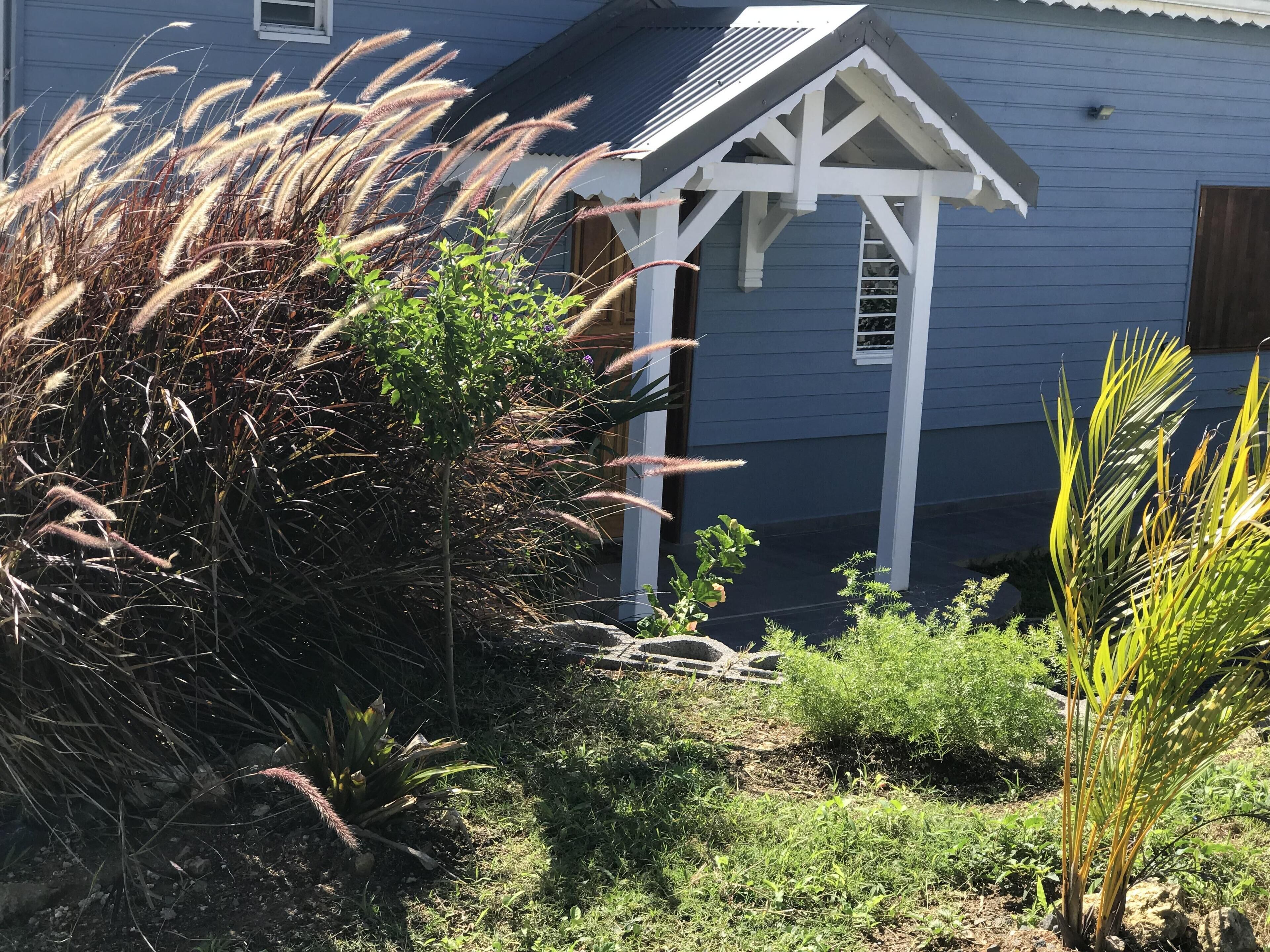 A house with a porch and a garden.