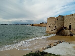Perched on a coastal bluff, this historic fortification offers stunning views of the ocean and a nearby cityscape.