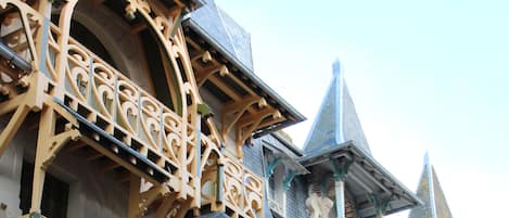 A building with ornate balconies and detailed architectural design.