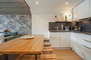 Enjoy meals at the kitchen's dining table with bench seating.