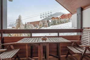 Relax in a sheltered outdoor seating area overlooking the ski slope.