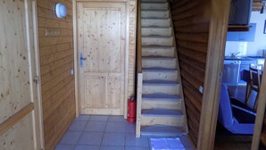 Ein Holzinnenraum mit einer Treppe, die zu einer Küchenzeile führt.