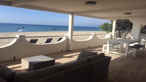 A covered outdoor seating area with a view of the beach and ocean. - T4 feet in water  (Ghisonaccia)