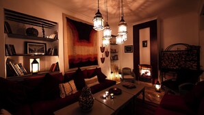 Een gezellige woonkamer met een bank, een salontafel en een open haard.