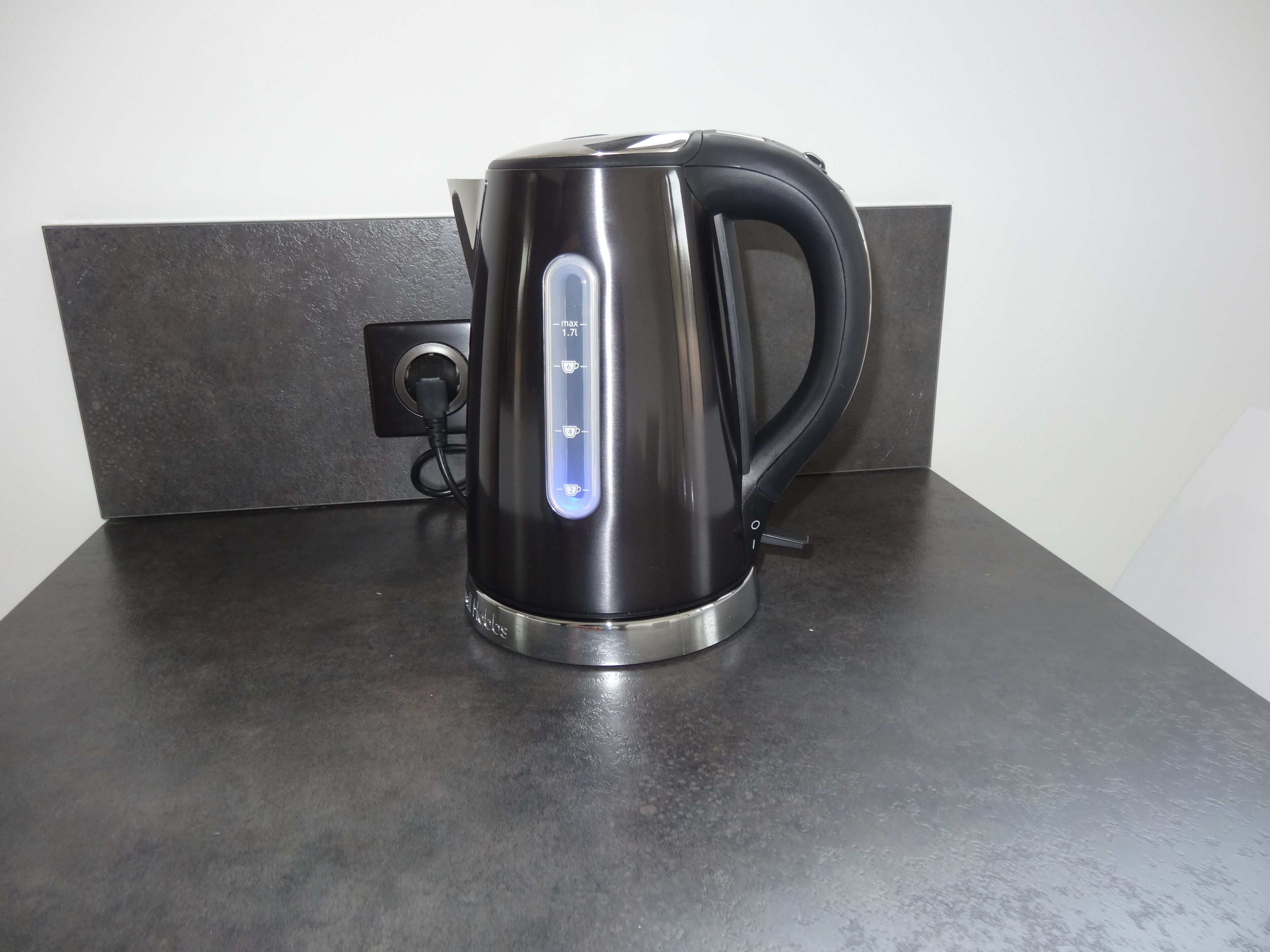 A stainless steel electric kettle on a countertop.
