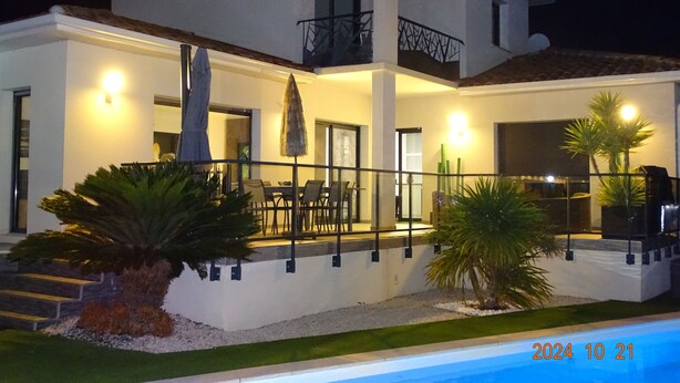 A modern two-story house with a pool, outdoor seating, and a well-lit balcony. - NEAR PEZENAS, lovely villa, private heated pool, quiet location, shops. (Tourbes)