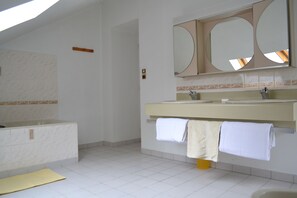 Bathtub, bidet, soap, toilet paper