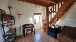 A room with a wooden staircase, a desk with a chair, a bookshelf, and a window. - Traditional house, spectacular view of the Gulf of Porto (Partinello)