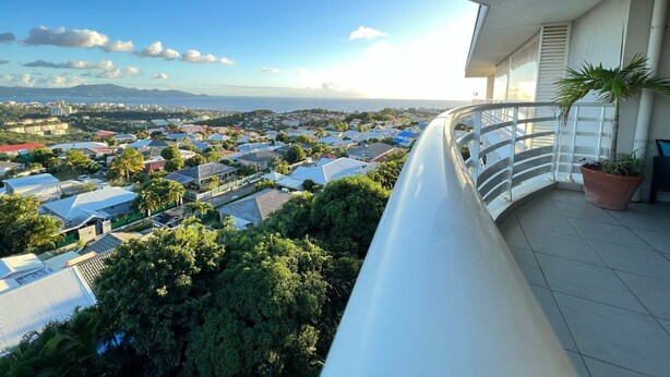 A balcony with a view of a residential area, including houses and greenery. - Luxury apartment with splendid sea view (Case-Pilote)