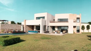 A modern two-story house with a swimming pool, outdoor seating, and a well-maintained lawn. - Luxurious villa with sea views in Essaouira (Essaouira)