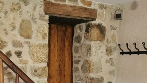 Eine Holzhandläufung führt zu einer Steinmauer.