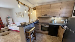 A modern kitchen with wooden cabinets, a built-in oven, and a black refrigerator. - San Cipriano (St Cyprien) 6 pers conditioned villa, in residence (Lecci)