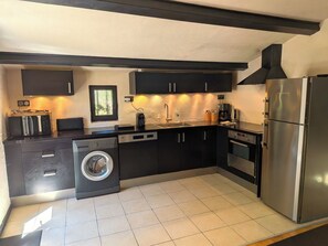 A compact kitchen with a washing machine, a built-in oven, and a refrigerator. - Private pool10X5, 11 bedr., 26 beds, 5 bath., 5 terraces, very quiet,10 000sqm park,AC (Uzès)