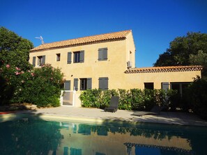 A two-story building with a swimming pool in front.